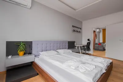 a bedroom with a large white bed in a room at The Honeycomb Hideaway by Flat Mаnager in Sofia