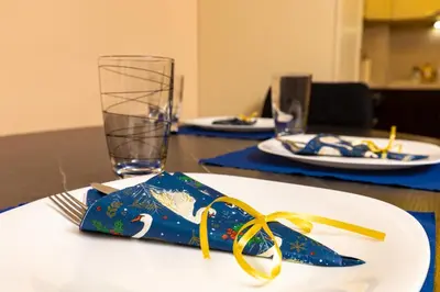 a table with a plate with a napkin with a whale on it at South Plovdiv - 2BD Flat with Balcony by Flat Mаnager in Plovdiv