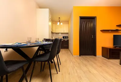 a dining room with a table and chairs and a kitchen at South Plovdiv - 2BD Flat with Balcony by Flat Mаnager in Plovdiv