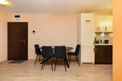 a dining room with a table and black chairs at South Plovdiv - 2BD Flat with Balcony by Flat Mаnager in Plovdiv