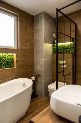 a bathroom with a white tub and a toilet at Какао Апартамент Велинград in Velingrad