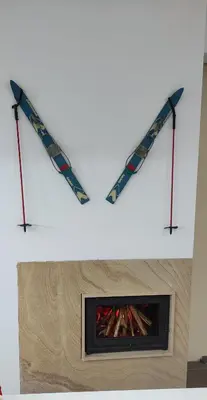 two skis hanging on a wall above a fireplace at Аpartment B201 Grand Bansko 1 in Bansko
