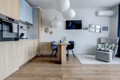 a kitchen and living room with a table and chairs at New Studio - 300m Subway - 10 Mins City Centre in Sofia