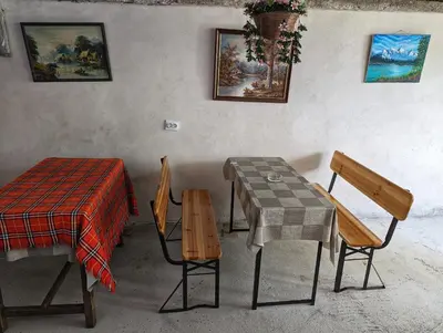a table and chairs in a room with a table and a table and chairs at Студио за гости - Лили in Ognyanovo