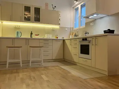 a kitchen with white cabinets and white appliances at Opera Flat in Sofia