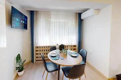 a dining room with a table and chairs at Апартамент в топ център София 5 Corners in Sofia