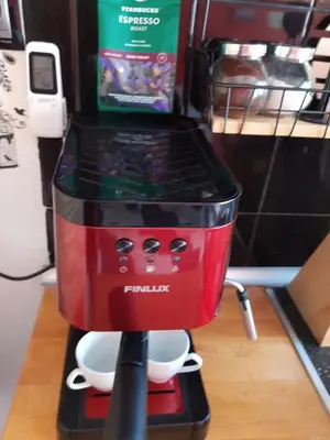 a red coffee maker on a stand on a shelf at Sofia Palms: Modern apartment with a large terrace in Sofia