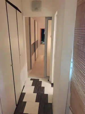 a hallway with doors and a tile floor at Sofia Palms: Modern apartment with a large terrace in Sofia