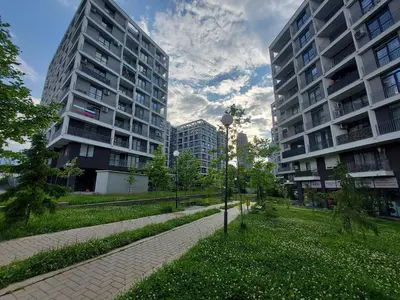 a park with two tall buildings and a street light at INTER EXPO APARTMENT in Sofia