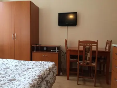 a bedroom with a bed and a desk and a tv at Studio in Cedar Lodge 3 in Bansko