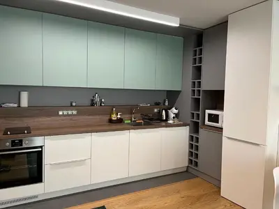 a kitchen with white cabinets and a counter top at Niko's deluxe apartment in Sofia