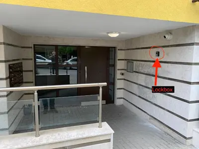 a red arrow pointing to the door of a building at Niko's deluxe apartment in Sofia