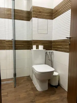 a bathroom with a toilet and a shower at Niko's deluxe apartment in Sofia