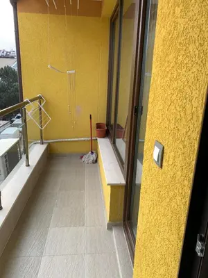 a bathroom with a shower with a yellow wall at Niko's deluxe apartment in Sofia