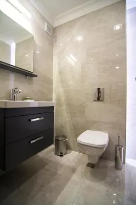 a bathroom with a white toilet and a sink at Odrys Apartments in Plovdiv