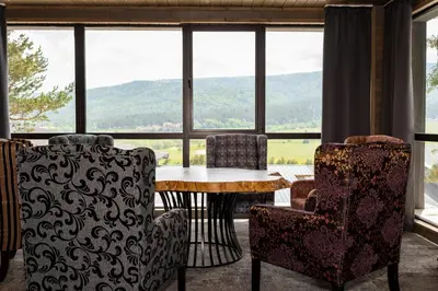 a room with a table and chairs and a large window at Grande Vista Resort & Spa in Tsigov Chark
