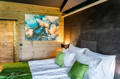 a bedroom with a bed with green and white pillows at Grande Vista Resort & Spa in Tsigov Chark
