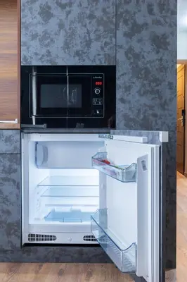 an open refrigerator with a microwave on top of it at View apartment #1 in Bansko