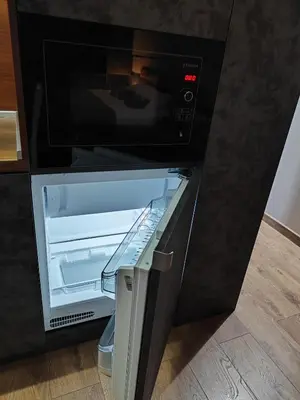 an empty refrigerator with its door open in a kitchen at View apartment #1 in Bansko