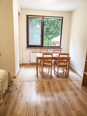 a dining room with a table and two chairs at Studio A10 Borovets gardens in Borovets