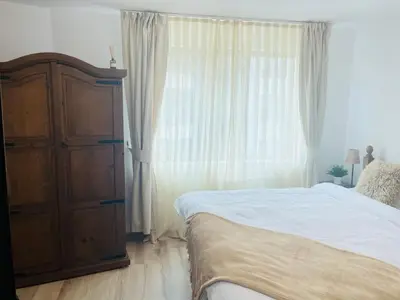 a bedroom with a bed and a large window at Apartment in Bansko, very close to the Gondola in Bansko