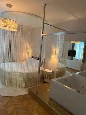a bathroom with a tub and a bedroom with a bed at Luxury apartment with Jacuzzi in Sofia