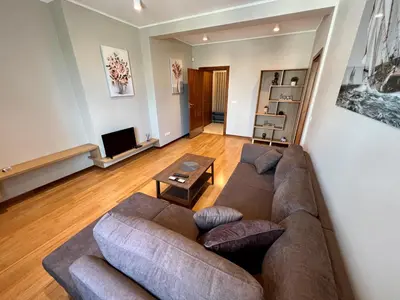 a living room with a couch and a tv at LOCATION ! LOCATION ! LOCATION ! City Garden View Oak apartment in Sofia