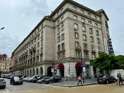 a large building with cars parked in front of it at LOCATION ! LOCATION ! LOCATION ! City Garden View Oak apartment in Sofia