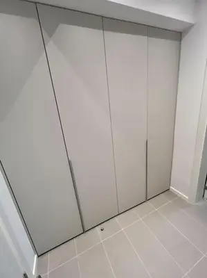 a room with white cabinets and a white floor at LOCATION ! Sofia Opera Apartment next to ALEXANDER NEVSKY CATHEDRAL in Sofia