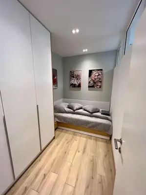 a bedroom with a bed in a room with a wooden floor at LOCATION ! Sofia Opera Apartment next to ALEXANDER NEVSKY CATHEDRAL in Sofia