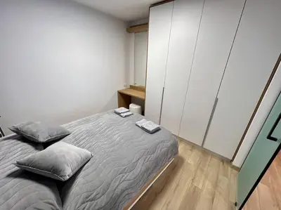 a bedroom with a bed with two pillows on it at LOCATION ! Sofia Opera View Apartment next to ALEXANDER NEVSKY CATHEDRAL in Sofia