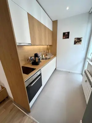 a small kitchen with a stove and a refrigerator at LOCATION ! Sofia Opera View Apartment next to ALEXANDER NEVSKY CATHEDRAL in Sofia