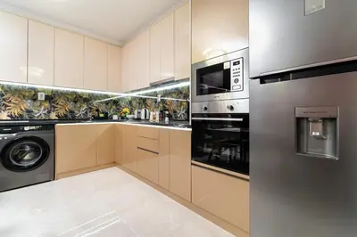 a kitchen with a washer and dryer at Modern & Elegant City Center Apartments in Plovdiv