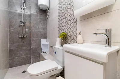 a bathroom with a toilet and a sink at Modern & Elegant City Center Apartments in Plovdiv