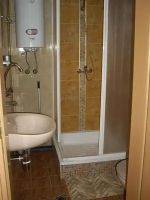 a bathroom with a shower and a sink and a toilet at Guest House Rusalka in Shipkovo