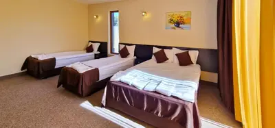 a room with two beds in a room at Семеен хотел Света Марина in Dobrinishte