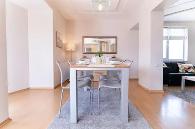 a living room with a white table and chairs at Spacious apartment in the city center in Plovdiv