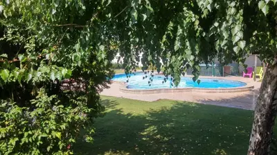 a large swimming pool with people in the water at Galeria In The Garden in Plovdiv