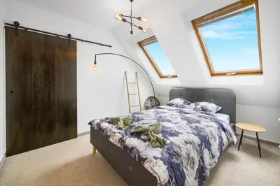 a bedroom with a bed and a wooden door at Top Central Maisonette with Underground parking in Sofia