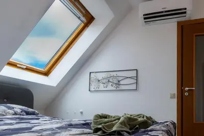 a bedroom with a window and a bed at Top Central Maisonette with Underground parking in Sofia