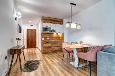 a kitchen and living room with a table and chairs at Secret Lake 533 at Oak Residence in Smolyan