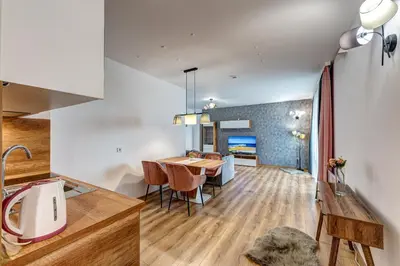 a kitchen and dining room with a table and chairs at Secret Lake 533 at Oak Residence in Smolyan