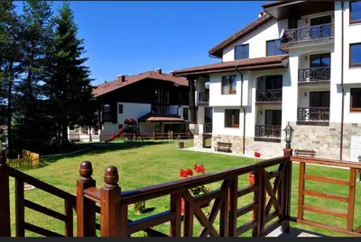 a wooden fence in front of a building with a yard at Secret Lake 533 at Oak Residence in Smolyan