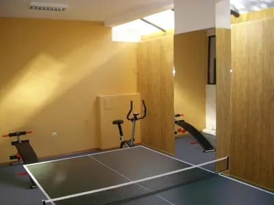 a gym with a ping pong table in a room at Apartments in Relax Complex Fantasy in Hisarya