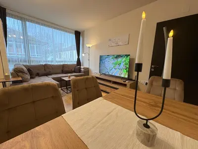 a living room with a couch and a table with a television at Two-bedroom Apartments - Tundza in Sofia