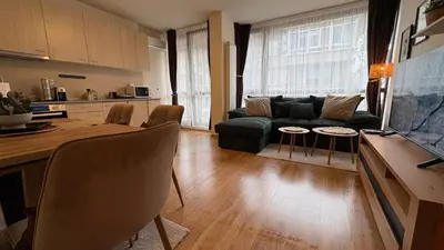 a living room with a couch and a table at Two-bedroom Apartments - Tundza in Sofia