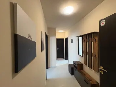 a hallway with a door leading to a room with windows at Two-bedroom Apartments - Tundza in Sofia