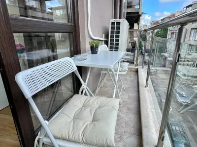 a white table and a chair on a balcony at Two-bedroom Apartments - Tundza in Sofia