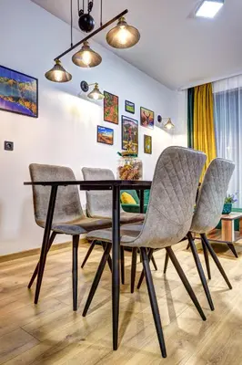 a dining room with a black table and chairs at Deer Lake 521 at Oak Residence Hotel & Relax in Smolyan