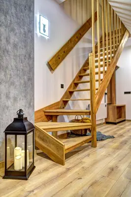 a staircase with a lantern in a room with wooden floors at Deer Lake 521 at Oak Residence Hotel & Relax in Smolyan
